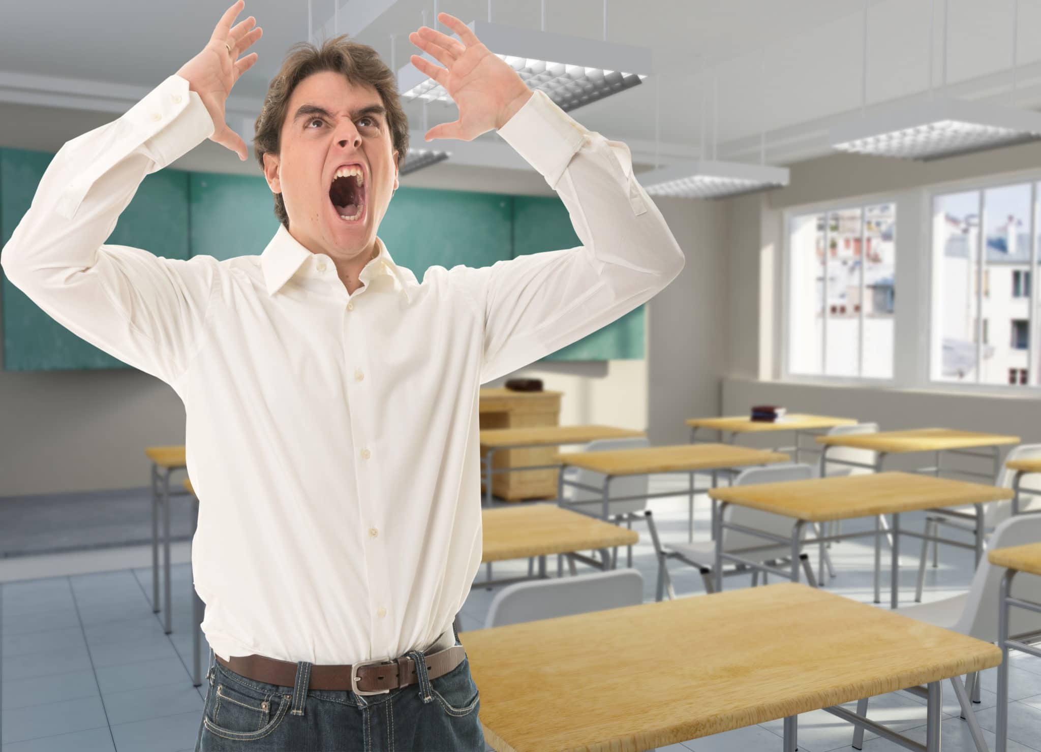 Angry young teacher in a classroom